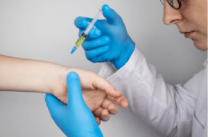 orthopedic surgeon gives an injection in the wrist.